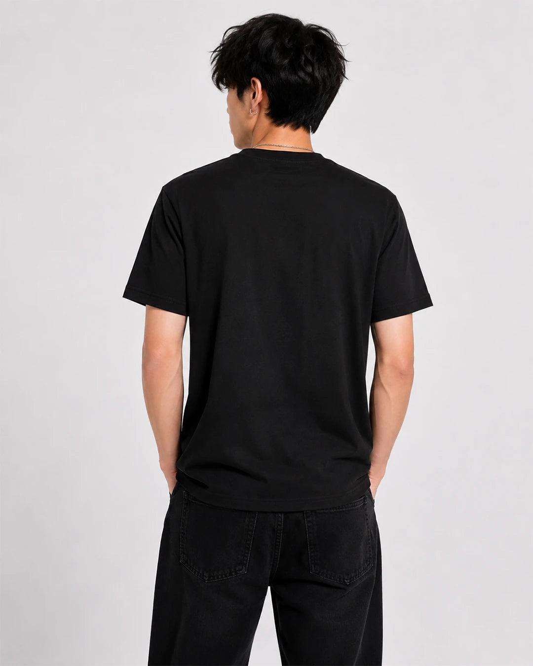 Model wearing black cat eyes T-shirt showing the plain black back