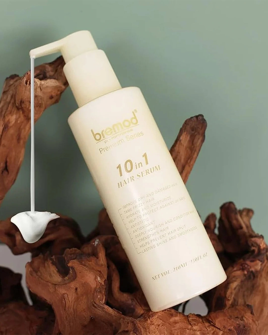Bremod Premium Series 10 in 1 Hair Cream Serum pump bottle displayed on natural wood for daily leave-in hair care