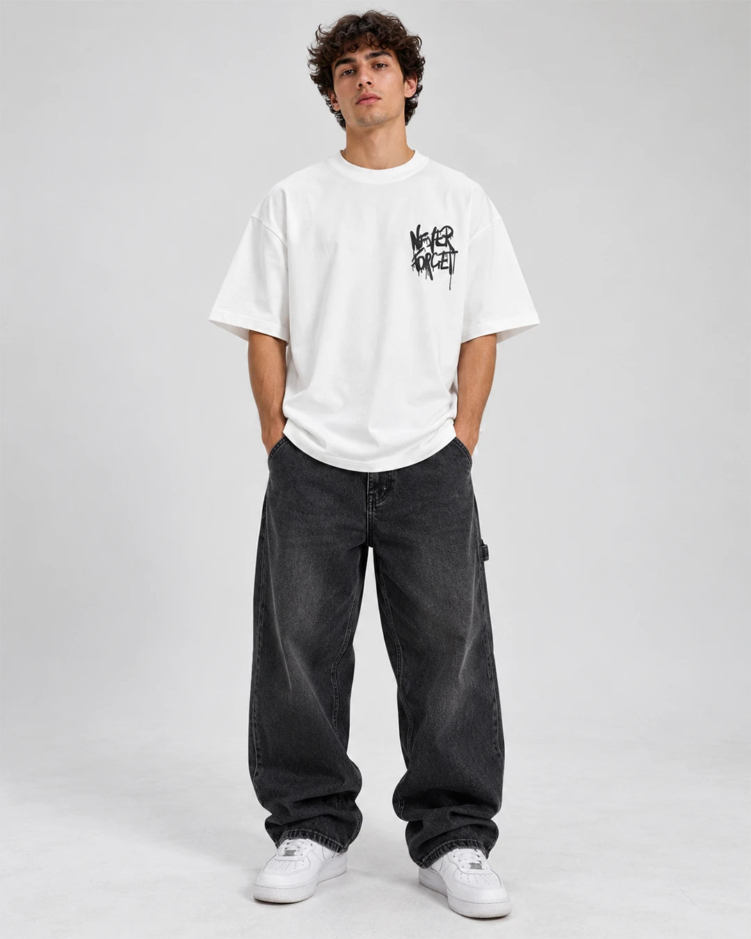 Model wearing a white duck oversized graphic T-shirt with baggy streetwear pants