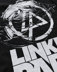 Close-up of Linkin Park distressed white LP logo and bold band lettering on black T-shirt