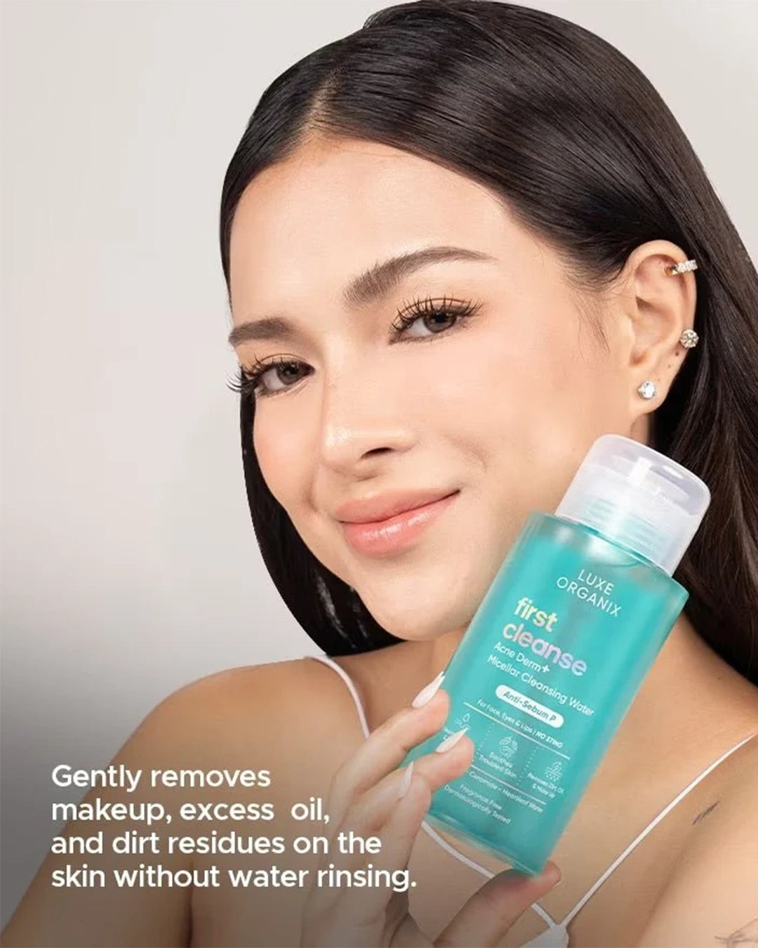 Model holding Luxe Organix First Cleanse Acne Derm+ Micellar Cleansing Water 300ml
