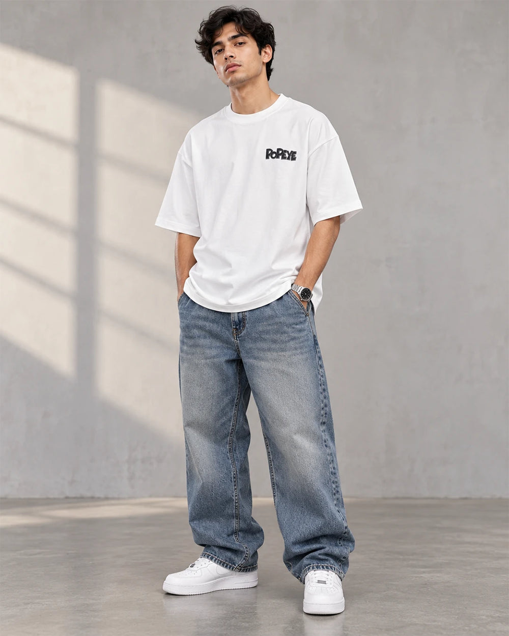 Model wearing a white Popeye oversized T-shirt with baggy streetwear pants
