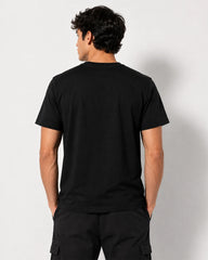 Model wearing Squid Game Player 456 black T-shirt showing the plain back