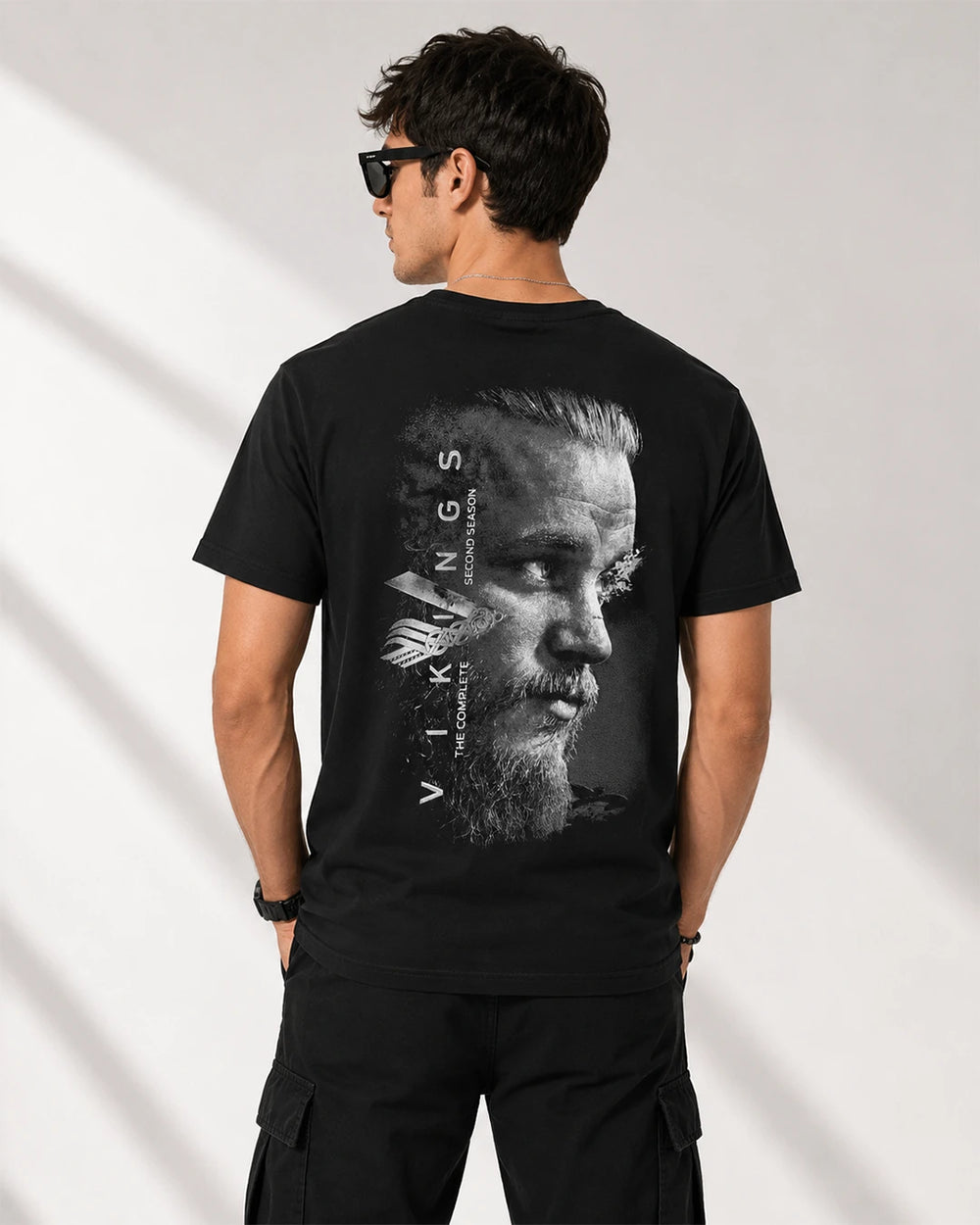 Model wearing Vikings black graphic T-shirt back view with matching back print